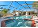 Gorgeous pool with a jacuzzi, brick trim, and screened-in lanai surrounded by patio at 910 Oakwood Dr, Largo, FL 33770