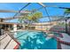 Inviting screened pool area with spa and brick deck at 910 Oakwood Dr, Largo, FL 33770