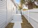 Neat side yard with a walkway and white fence at 3811 N Arlington Ave, Tampa, FL 33603