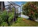 Landscaped backyard with lush greenery and pond views at 7820 Harbor Bridge, New Port Richey, FL 34654