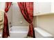 Bathroom with shower/tub combo and red patterned curtains at 7820 Harbor Bridge, New Port Richey, FL 34654