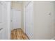 Light and bright hallway with hardwood floors and two doors at 7820 Harbor Bridge, New Port Richey, FL 34654