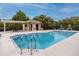 Community pool with a bathhouse and surrounding patio at 7820 Harbor Bridge, New Port Richey, FL 34654