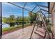 Relaxing screened patio overlooking a pond, complete with seating and a swing at 7820 Harbor Bridge, New Port Richey, FL 34654