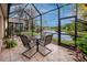 Screened patio overlooking a pond with seating for four at 7820 Harbor Bridge, New Port Richey, FL 34654