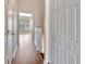 Long hallway with wood floors and access to other rooms at 10316 Estero Bay Ln, Tampa, FL 33625