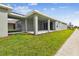 Covered patio and grassy backyard with a walkway at 28732 Rambutan Dr, Wesley Chapel, FL 33543