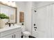 Modern bathroom featuring white cabinets, black fixtures, and a shower with white subway tile at 28732 Rambutan Dr, Wesley Chapel, FL 33543