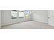 Bright bedroom with neutral carpeting and multiple windows at 28732 Rambutan Dr, Wesley Chapel, FL 33543