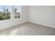 Bright bedroom with two windows and carpeted floor at 28732 Rambutan Dr, Wesley Chapel, FL 33543
