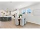 Bright dining area adjacent to the modern kitchen, featuring a round table and stylish pendant lights at 28732 Rambutan Dr, Wesley Chapel, FL 33543