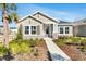 Beautiful single-story home showcasing stone accents, tidy landscaping, and a welcoming covered entryway at 28732 Rambutan Dr, Wesley Chapel, FL 33543