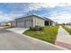 Two-car garage with driveway and landscaping at 28732 Rambutan Dr, Wesley Chapel, FL 33543
