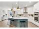 Bright kitchen featuring an island with seating, modern appliances, and seamless flow to the spacious living area at 28732 Rambutan Dr, Wesley Chapel, FL 33543