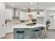 Modern kitchen showcasing a large island, pendant lighting, and sleek white cabinets, perfect for culinary enthusiasts at 28732 Rambutan Dr, Wesley Chapel, FL 33543