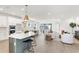 Open kitchen featuring a large island with seating, stainless steel appliances, and seamless flow to the living area at 28732 Rambutan Dr, Wesley Chapel, FL 33543