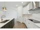 Modern kitchen with white cabinets, gas cooktop and stainless steel appliances at 28732 Rambutan Dr, Wesley Chapel, FL 33543