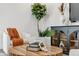 Close-up of a modern living room featuring a round wooden coffee table and stylish decor at 28732 Rambutan Dr, Wesley Chapel, FL 33543