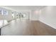 Spacious living room with hardwood floors and sliding glass doors at 28732 Rambutan Dr, Wesley Chapel, FL 33543
