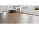 Large living area with hardwood floors and access to the kitchen at 28732 Rambutan Dr, Wesley Chapel, FL 33543