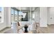 Inviting sitting area with comfortable chairs, natural light, and views of the outdoors through sliding glass doors at 28732 Rambutan Dr, Wesley Chapel, FL 33543