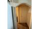 A hallway with arched doorway to bedroom at 38424 Fir Ave, Zephyrhills, FL 33542