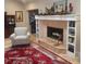 Cozy living room with fireplace, built-in shelves, and area rug at 815 3Rd S Ave, Tierra Verde, FL 33715