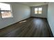 Bright bedroom featuring hardwood floors and large windows at 5732 Silverside Pine Ct, Lakewood Ranch, FL 34211