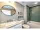 Updated bathroom with green tile and marble vanity at 13313 Gasparilla Rd # 402, Placida, FL 33946