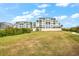 Building exterior and grounds with grassy area at 13313 Gasparilla Rd # 402, Placida, FL 33946