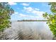 Scenic waterfront view with calm water and lush vegetation at 13313 Gasparilla Rd # 402, Placida, FL 33946