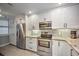 Modern kitchen with stainless steel appliances and granite countertops at 13313 Gasparilla Rd # 402, Placida, FL 33946