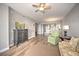 Living room with wood floors, green chair and view to dining area at 13313 Gasparilla Rd # 402, Placida, FL 33946