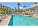 Community pool with lounge chairs and nearby building at 13313 Gasparilla Rd # 402, Placida, FL 33946