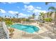 Community pool with lounge chairs and a gazebo at 13313 Gasparilla Rd # 402, Placida, FL 33946