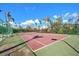 Community tennis court with seating and surrounding fence at 13313 Gasparilla Rd # 402, Placida, FL 33946