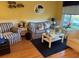 Living room features hardwood floors, striped sofas, and a coffee table at 2100 World Parkway Blvd # 14, Clearwater, FL 33763