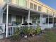 Covered patio with white railing and potted plants at 2100 World Parkway Blvd # 14, Clearwater, FL 33763