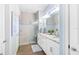 Bathroom with double vanity, granite countertop, and a large walk-in shower at 200 Soliera St, Nokomis, FL 34275