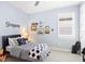 Charming bedroom with a twin-size bed, nautical theme, and ample closet space at 200 Soliera St, Nokomis, FL 34275