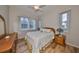 Cozy bedroom with wood-look floors, a queen-size bed, and ample natural light at 2226 Sifield Greens Way # 26, Sun City Center, FL 33573