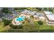 Aerial view of community pool, clubhouse, and parking at 2226 Sifield Greens Way # 26, Sun City Center, FL 33573