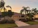 Well-maintained house with a driveway and palm trees at 2226 Sifield Greens Way # 26, Sun City Center, FL 33573