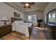 Main bedroom with king-size bed, wood dresser, and ceiling fan at 2226 Sifield Greens Way # 26, Sun City Center, FL 33573