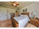 Large main bedroom with king-size bed, ceiling fan, and plenty of natural light at 2226 Sifield Greens Way # 26, Sun City Center, FL 33573