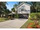 Two-story home featuring a two-car garage, landscaped front yard, and a neutral color scheme at 2457 Hickman Cir, Clearwater, FL 33761