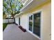 Backyard featuring a concrete patio with a sliding glass door to the interior of the home at 3915 W San Pedro St, Tampa, FL 33629