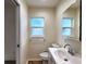 Bright bathroom showcasing a modern vanity, toilet, and a window offering natural light at 3915 W San Pedro St, Tampa, FL 33629