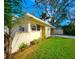 Side view of a well-maintained home with a lush lawn and a private carport at 3915 W San Pedro St, Tampa, FL 33629