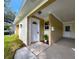 Inviting front entrance with a covered porch, stylish door, and neat landscaping at 3915 W San Pedro St, Tampa, FL 33629